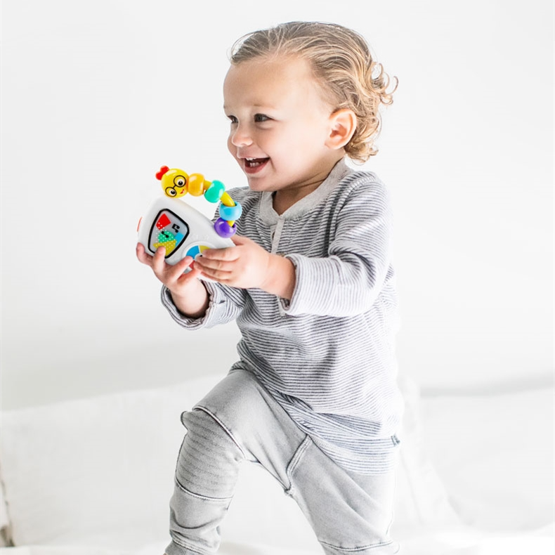 toddler playing with the caterpillar jukebox